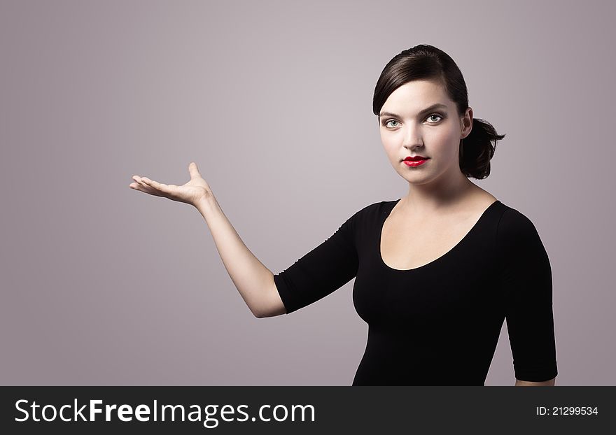 Woman presenting something imaginary with her right hand, vintage colors