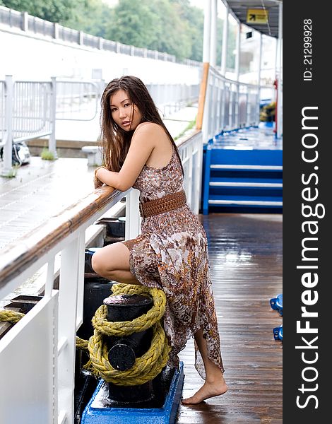 Traveling girl standing on board a ship