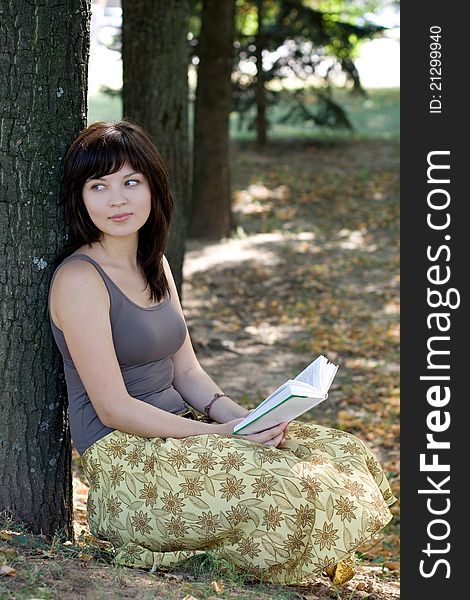 Girl reading book in park