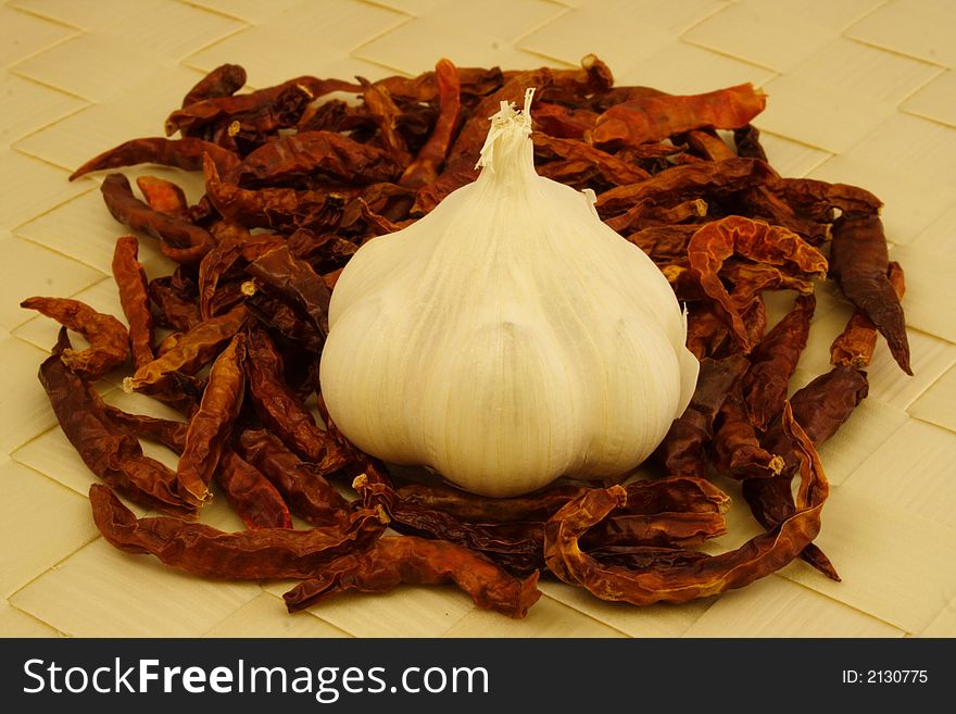Garlic on a bed of dried chilli pepper. Garlic on a bed of dried chilli pepper