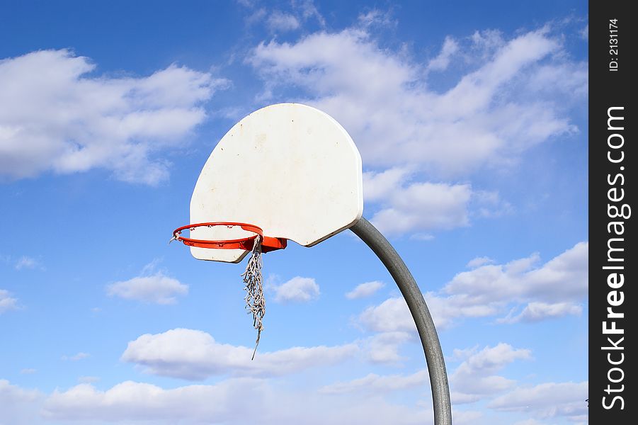 Photo of basket ball board with blue sky and nice clouds