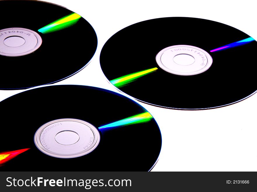 Few compact discs on a white background.