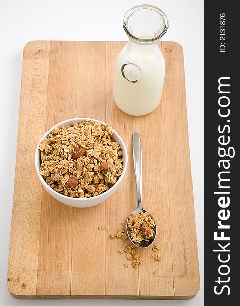 Bowl of healthy granola and a bottle of milk. Bowl of healthy granola and a bottle of milk