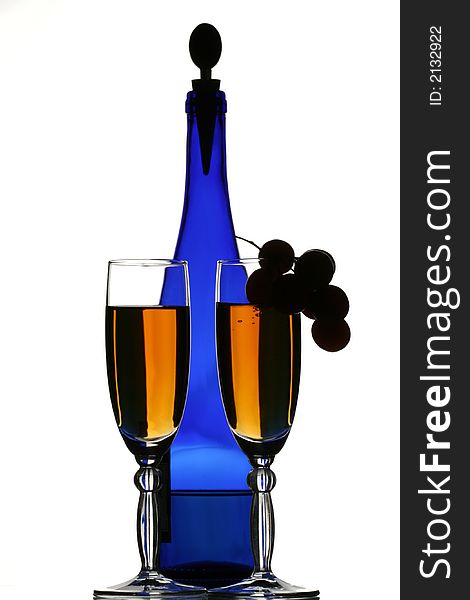 Dark blue bottle of wine, glasses with wine and grapes. Dark blue bottle of wine, glasses with wine and grapes