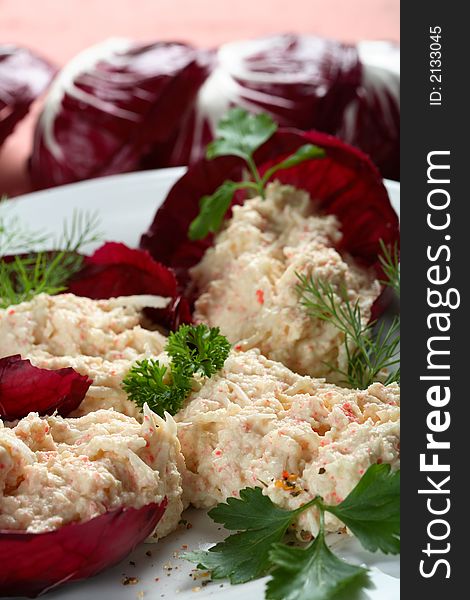 Red cabbage with crab mayonnaise decorated with parsley and dill