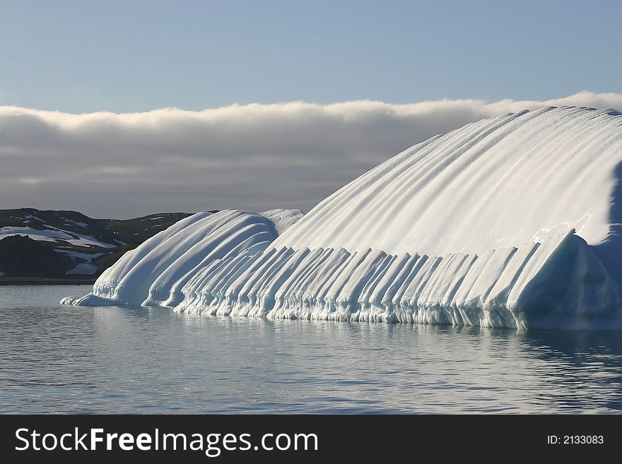 big rounded iceberg modified by wind and water. big rounded iceberg modified by wind and water