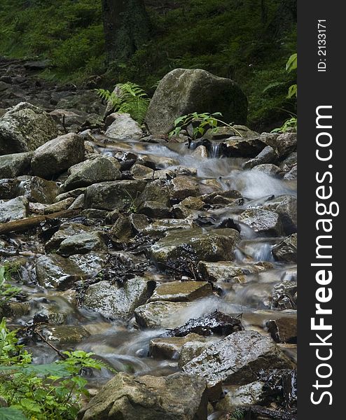 A stream or creek, is a body of water with a detectable current, confined within a bed and banks. A stream or creek, is a body of water with a detectable current, confined within a bed and banks.