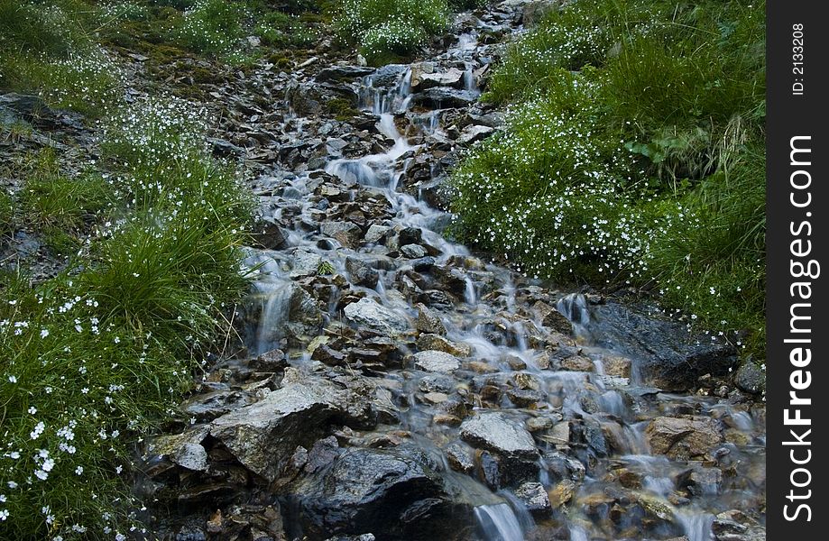 A stream or creek, is a body of water with a detectable current, confined within a bed and banks. A stream or creek, is a body of water with a detectable current, confined within a bed and banks.