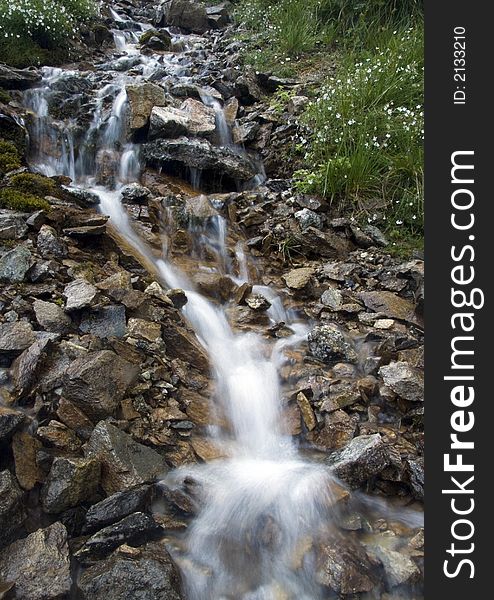 A stream or creek, is a body of water with a detectable current, confined within a bed and banks. A stream or creek, is a body of water with a detectable current, confined within a bed and banks.