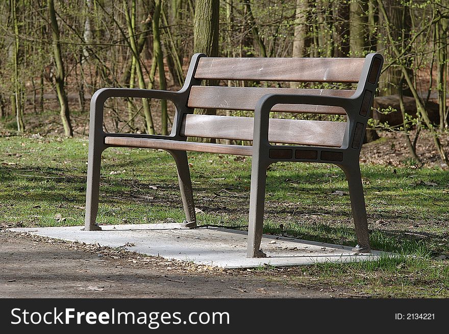 Empty park bench on a sunny day