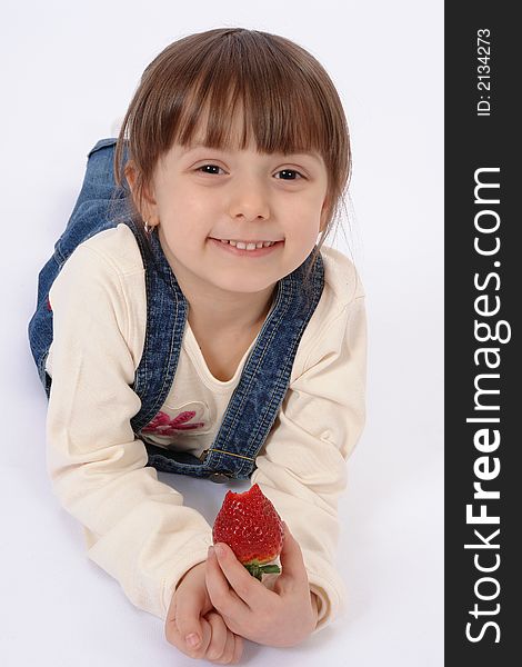 Isolated portrait of little girl who eates strawberry. Isolated portrait of little girl who eates strawberry