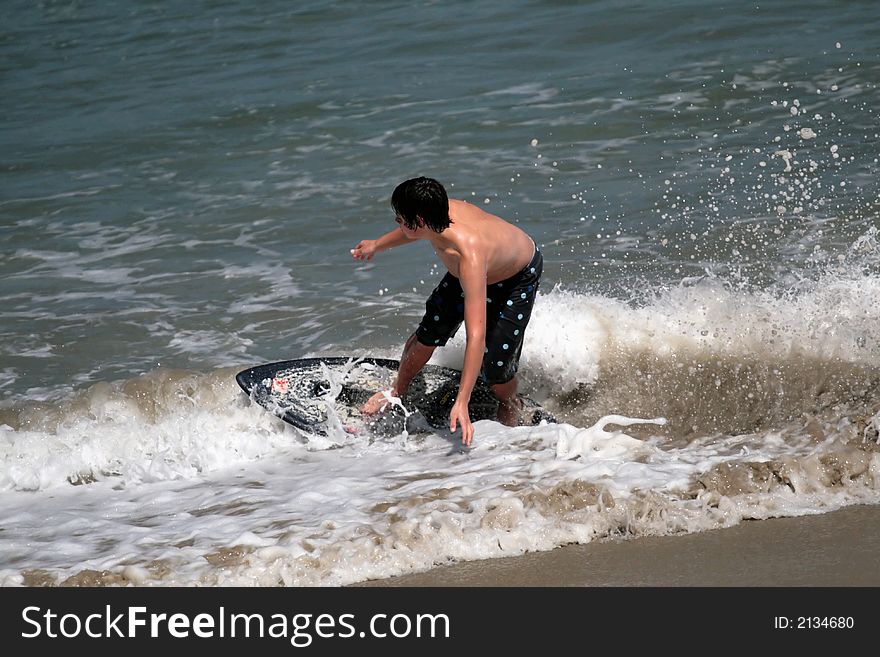 Young man boogie boarding in the Pacific