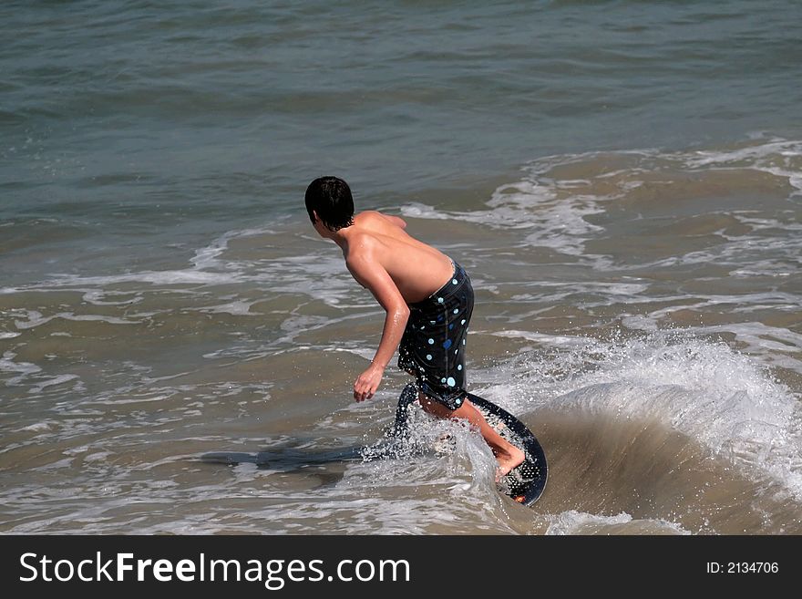 Young man boogie boarding in the Pacific