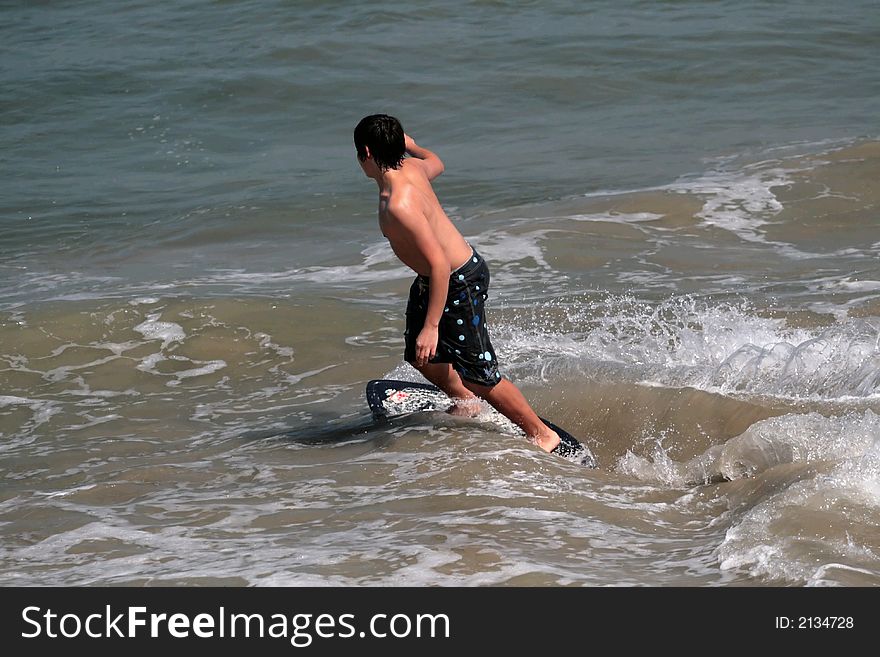 Young man boogie boarding in the Pacific