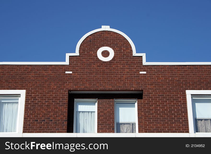 Facade and ornamental rooftop of a red brick house. Facade and ornamental rooftop of a red brick house.