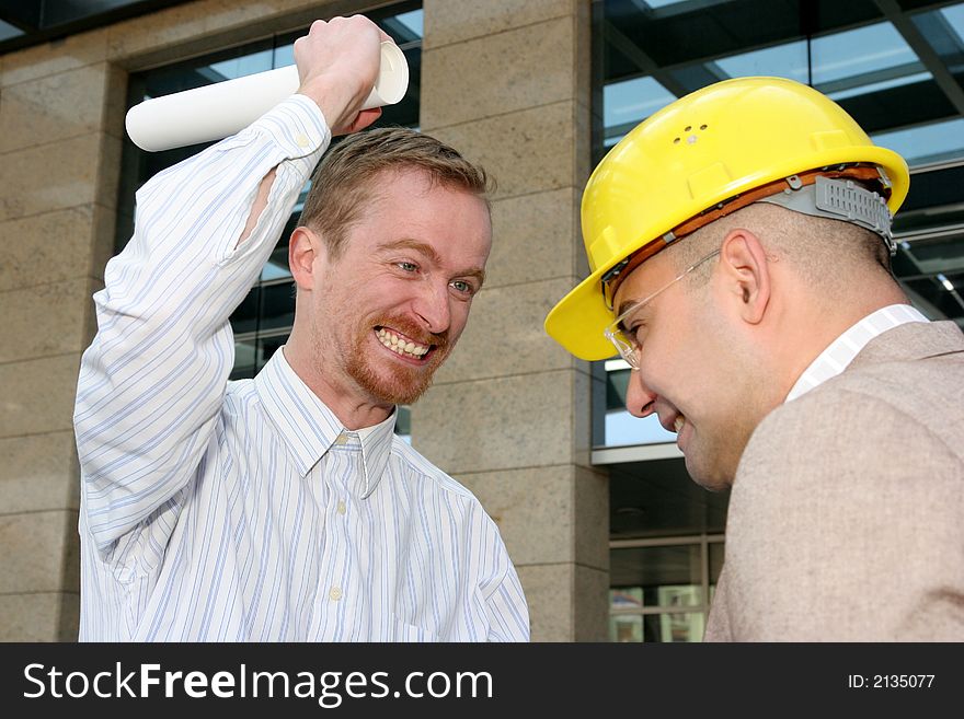 Angry architect and businessman with architectural plans