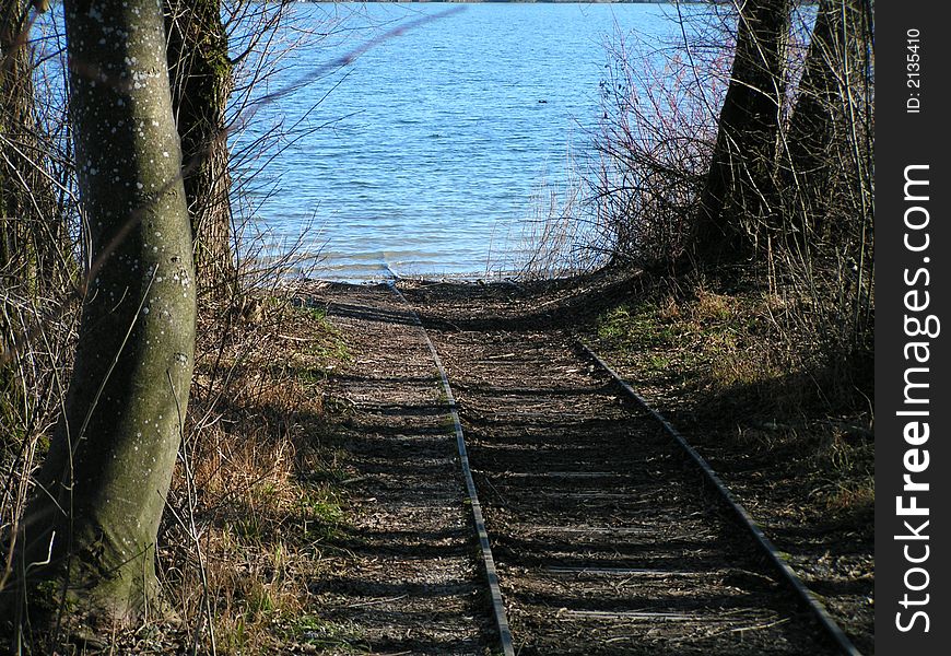 Boating railing goes to the lake. South Germany, Chiemsee lake.