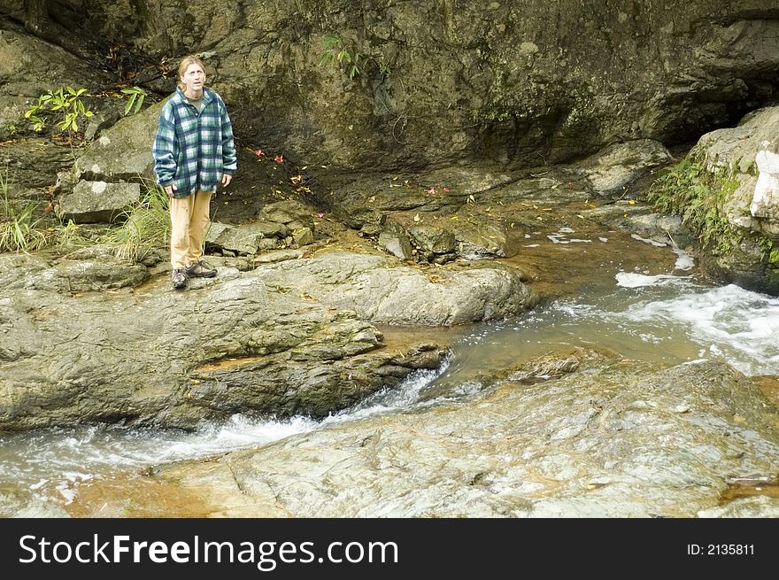 Woman hiking and crossing a river. Woman hiking and crossing a river