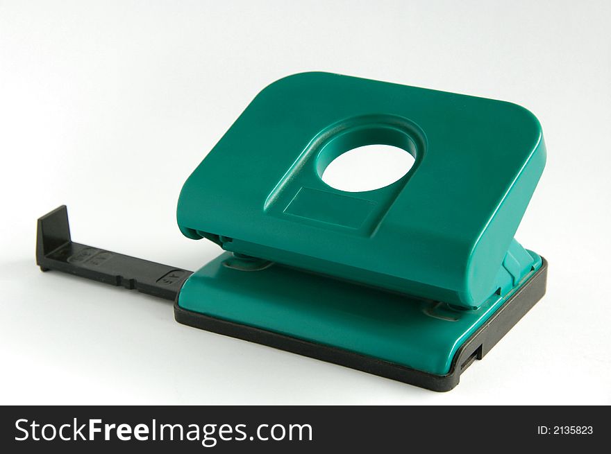 Green hole punch with white background