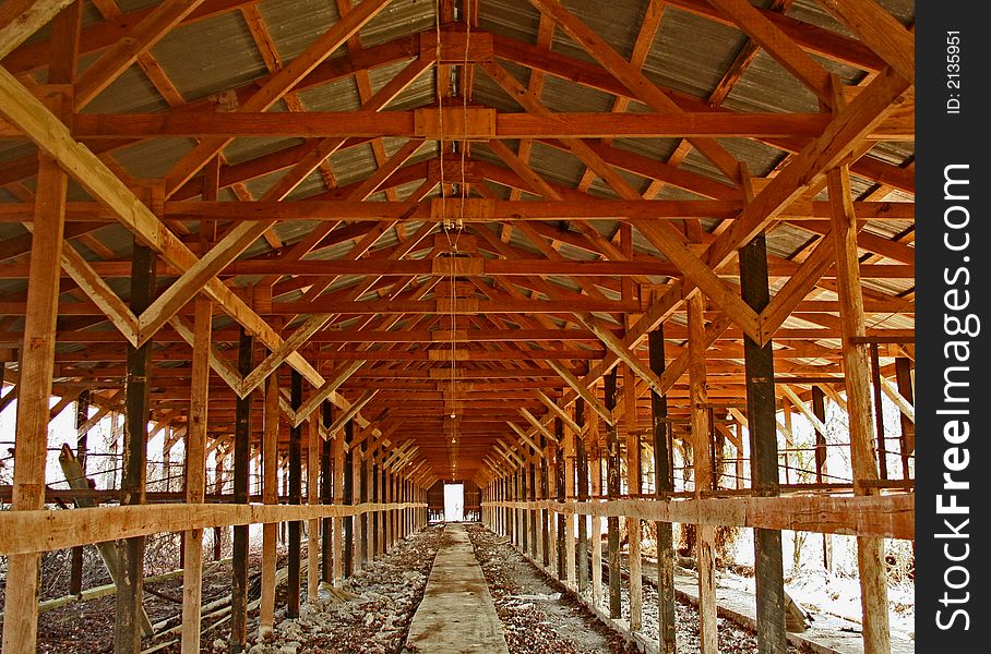 Image of inside of long wooden building giving the effect of tunnel vision