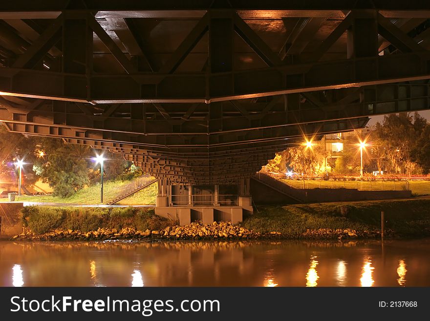 A long exposure night view of the bottom of a bridge. A long exposure night view of the bottom of a bridge
