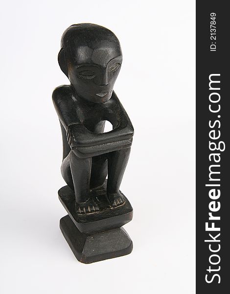 Black wooden idol statue on white background. Black wooden idol statue on white background