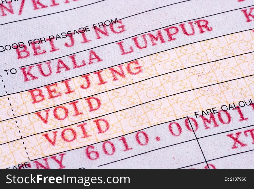 Extreme close up on airline ticket from Beijing to Kuala Lumpur.