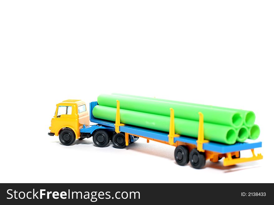 Picture of a old small Bedford Pipe Transporter truck. Greek plastic toy from my brothers toy collection. Isolated on real white. Picture of a old small Bedford Pipe Transporter truck. Greek plastic toy from my brothers toy collection. Isolated on real white