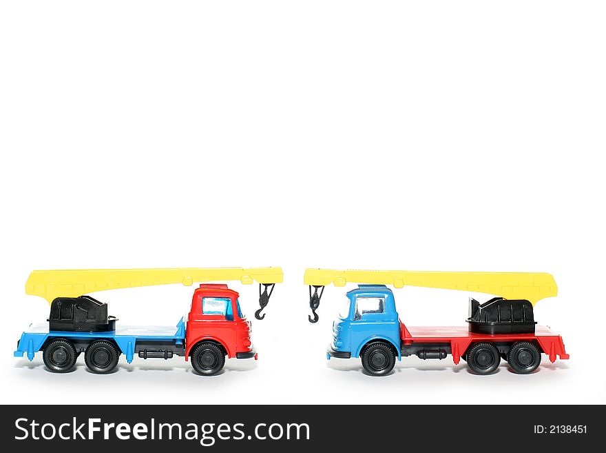 Picture of 2 old small Bedford crane trucks. Greek plastic toy from my brothers toy collection. Isolated on real white. Picture of 2 old small Bedford crane trucks. Greek plastic toy from my brothers toy collection. Isolated on real white