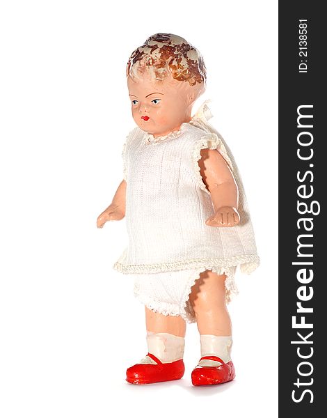 Picture of a old abused porcelain girl doll. Dates around 1950 or later .Isolated on real white. Picture of a old abused porcelain girl doll. Dates around 1950 or later .Isolated on real white