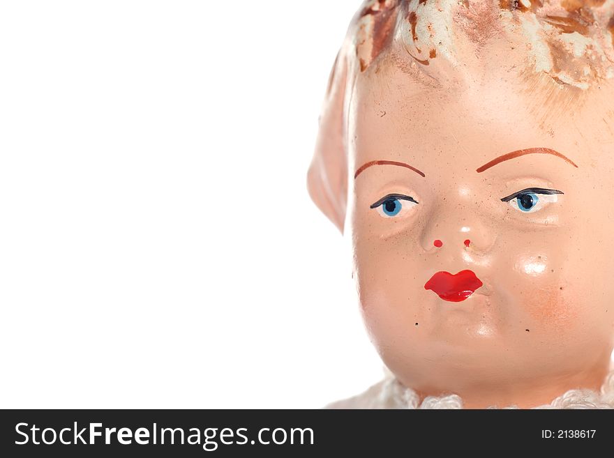 Picture of a old abused porcelain girl doll face. Dates around 1950 or later .Isolated on real white. Picture of a old abused porcelain girl doll face. Dates around 1950 or later .Isolated on real white