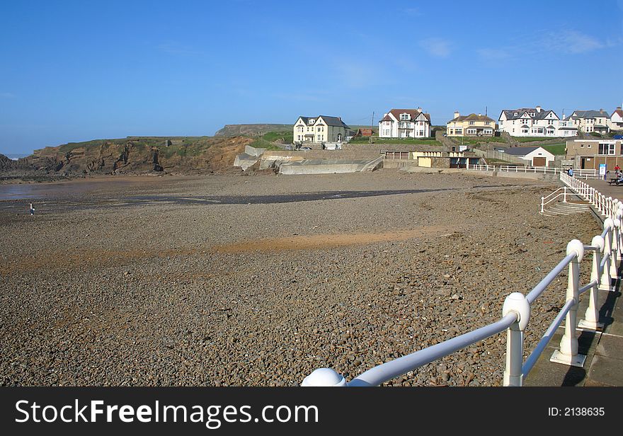 View across a stoney beach to overlooking residential buildings