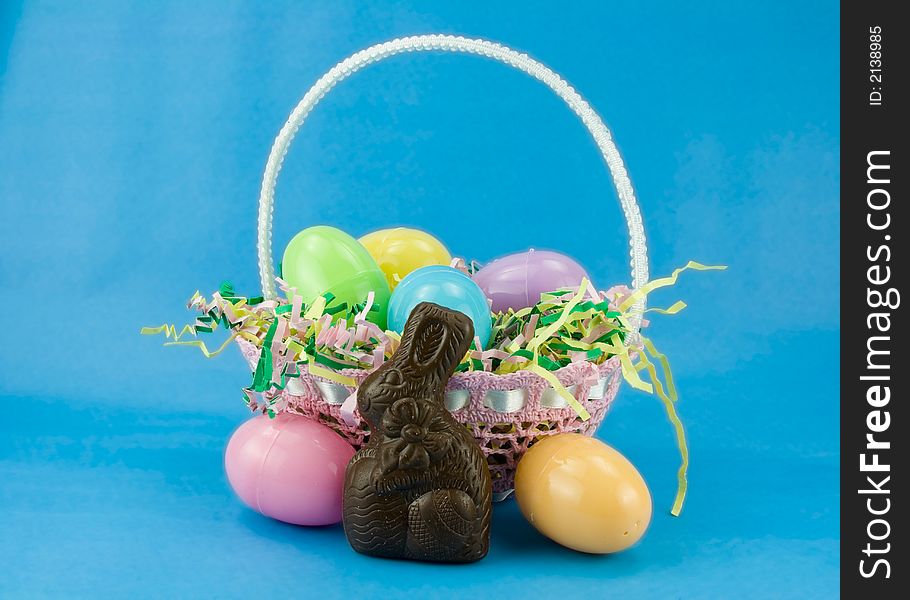 A filled easter basket with plastic eggs and a chocolate bunny