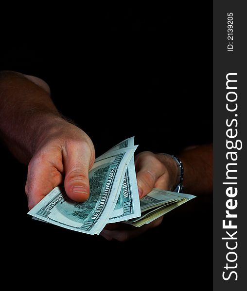 View of woman’s hand counting money in the dark. View of woman’s hand counting money in the dark