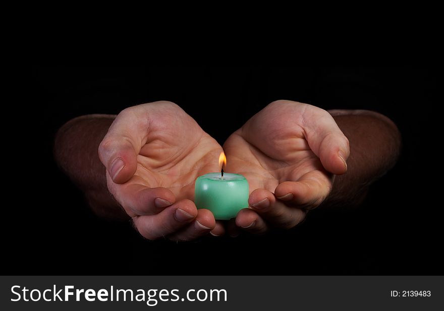 View of  hands holding candle in the dark. View of  hands holding candle in the dark