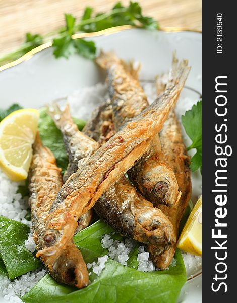 Oven Sprats put on the lettuce with lemon