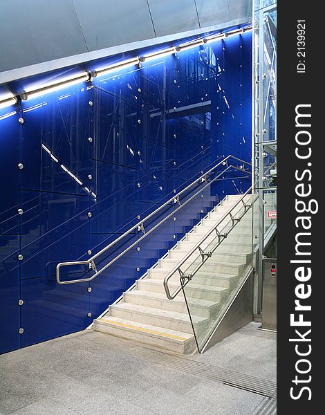 Stairway with walls of blue glassplates. Bannisters ans fastening units are of polished steel. Stairway with walls of blue glassplates. Bannisters ans fastening units are of polished steel.