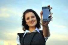 Lovely Young Woman Showing Mobile Phone Royalty Free Stock Photo