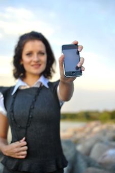 Lovely Young Woman Showing Mobile Phone Stock Image