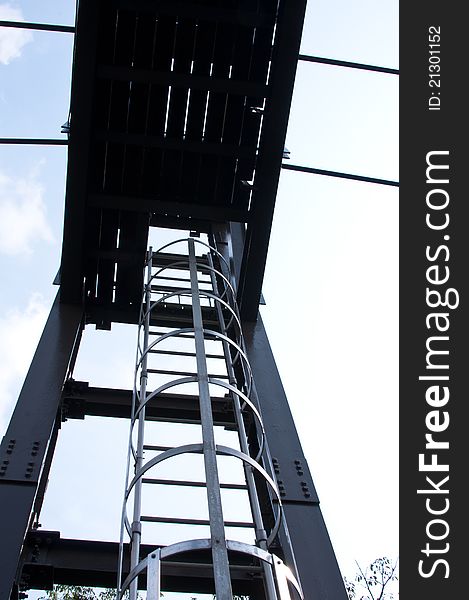 Enclosed metal ladder on a steel structure for safety and prevent from fall. Enclosed metal ladder on a steel structure for safety and prevent from fall