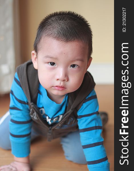 Cute chinese kid sit on floor indoor. Cute chinese kid sit on floor indoor