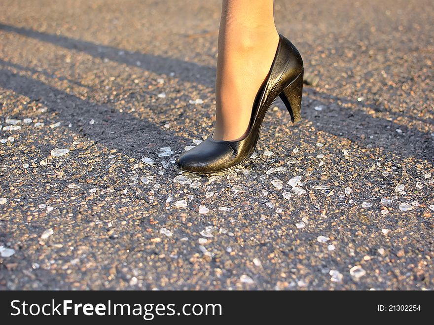 Women's foot steps on the broken glass. Women's foot steps on the broken glass