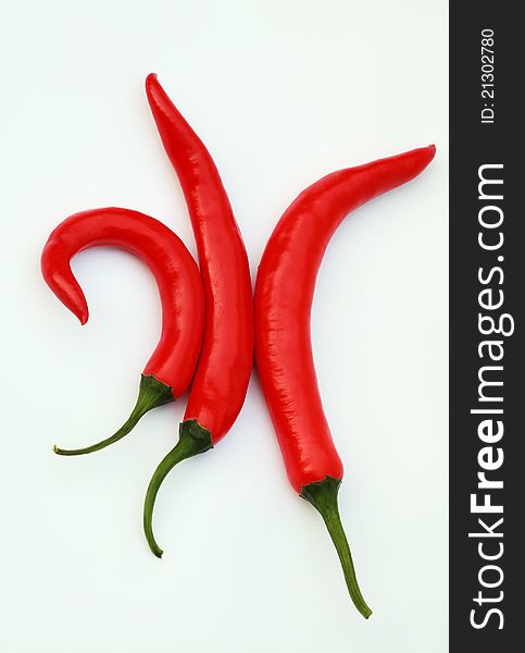 Three red chillies isolated on white background. Three red chillies isolated on white background