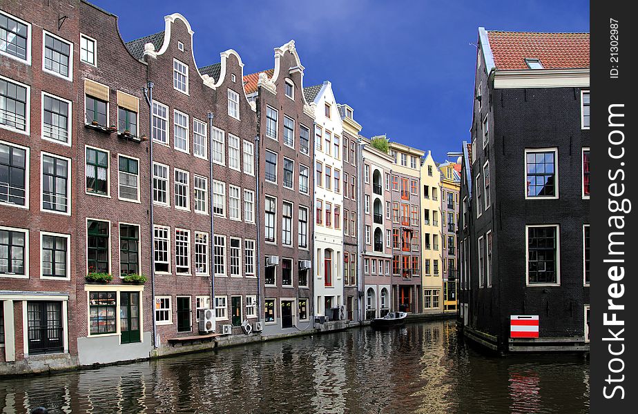 Amsterdam houses facade with water and blue sky. Amsterdam houses facade with water and blue sky