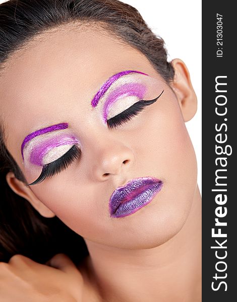 Close up of an Asian female's face wearing purple makeup. Close up of an Asian female's face wearing purple makeup