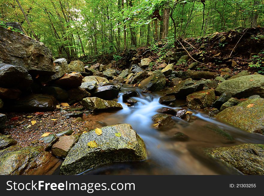 Beautiful stream with soft light and flowing waterfall. Beautiful stream with soft light and flowing waterfall.