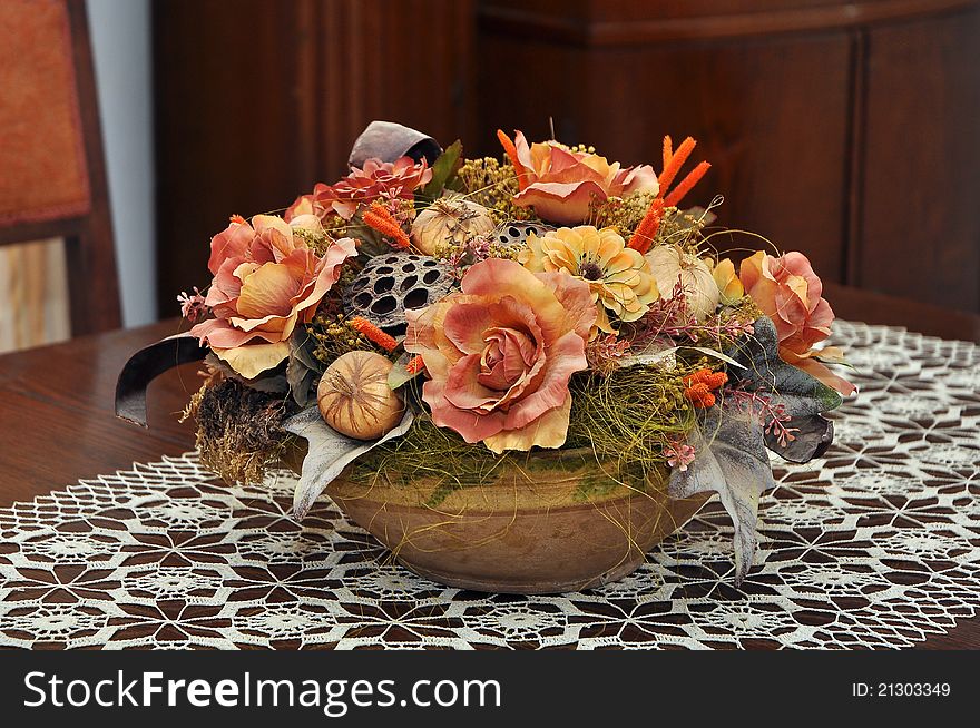 Artificial decorative flowers on a wooden table