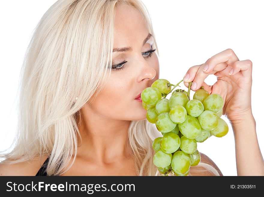 Blonde in black bathing suit eating grapes. Blonde in black bathing suit eating grapes