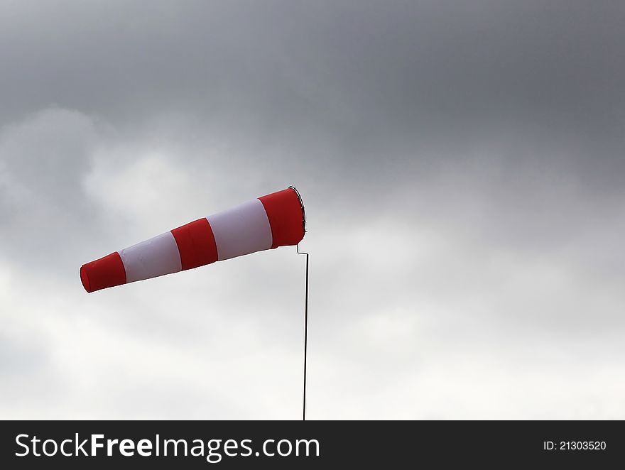 Windsock close-up against the sky with clouds