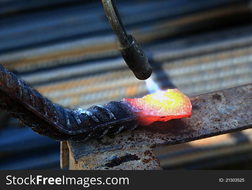 Heating up a steel rod with a blowpipe